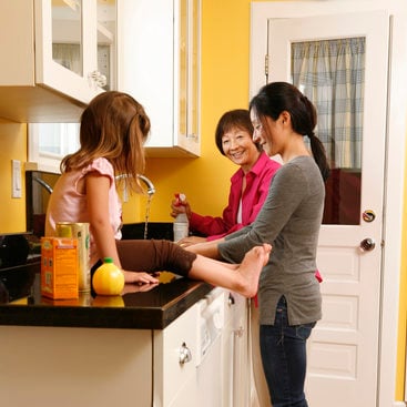 photo of a family using green cleaners in the kitchen
