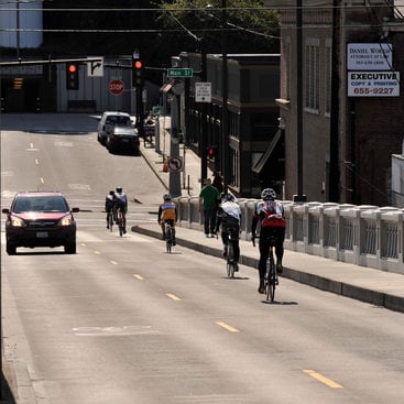 photo of bikes and cars on bridge