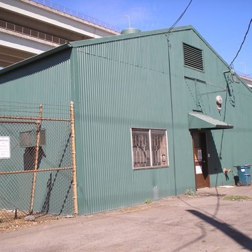 industrial building covered with green corrugated aluminum siding