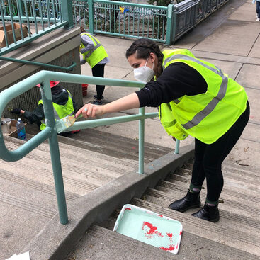 An image of a person cleaning up graffiti