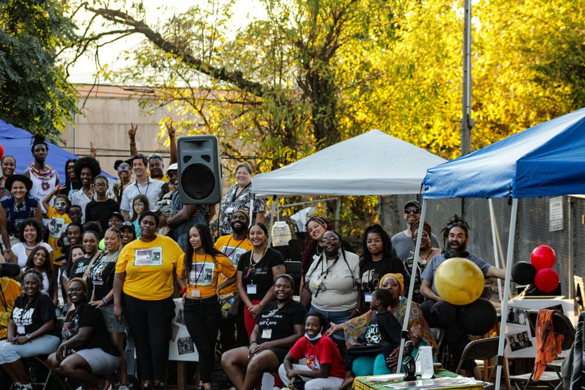 A group photo at the Afro-topia pop-up of mostly Black and brown folks