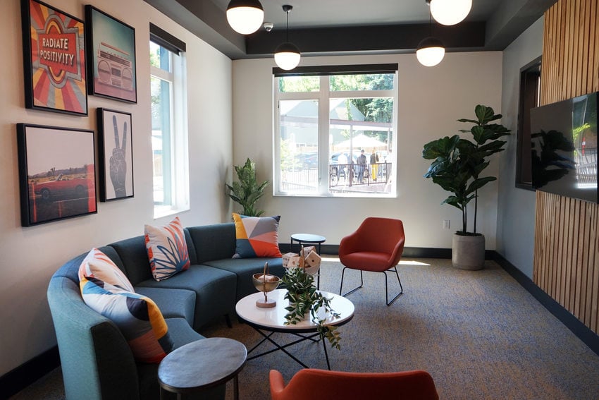 Lounge with mid-century furniture and framed art.