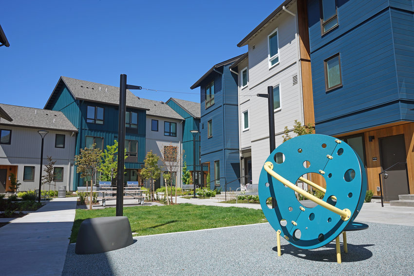 Apartment building courtyard with play structure in foreground. 