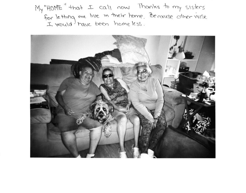 Three older women sitting on a couch with a dog.