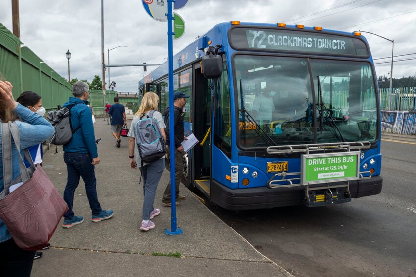 Several people line up to board the Line 72 Bus