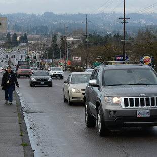People walking and driving on Pacific Highway in Tigard