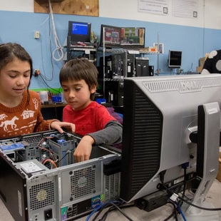two children learning to build a computer