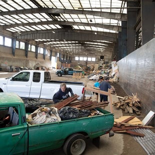 a man unloads construction waste at a transfer station