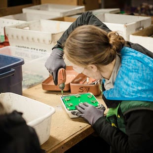 Free Geek volunteer prepares electronics for recycling.