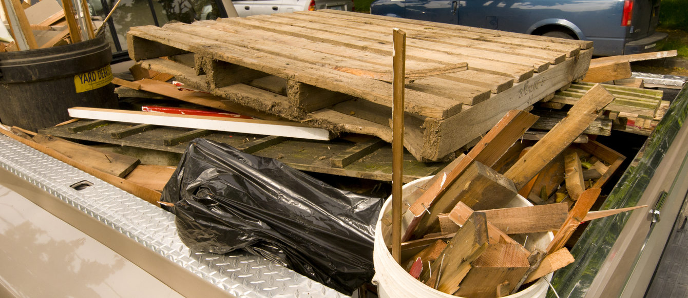 wood waste loaded into the bed of a pickup