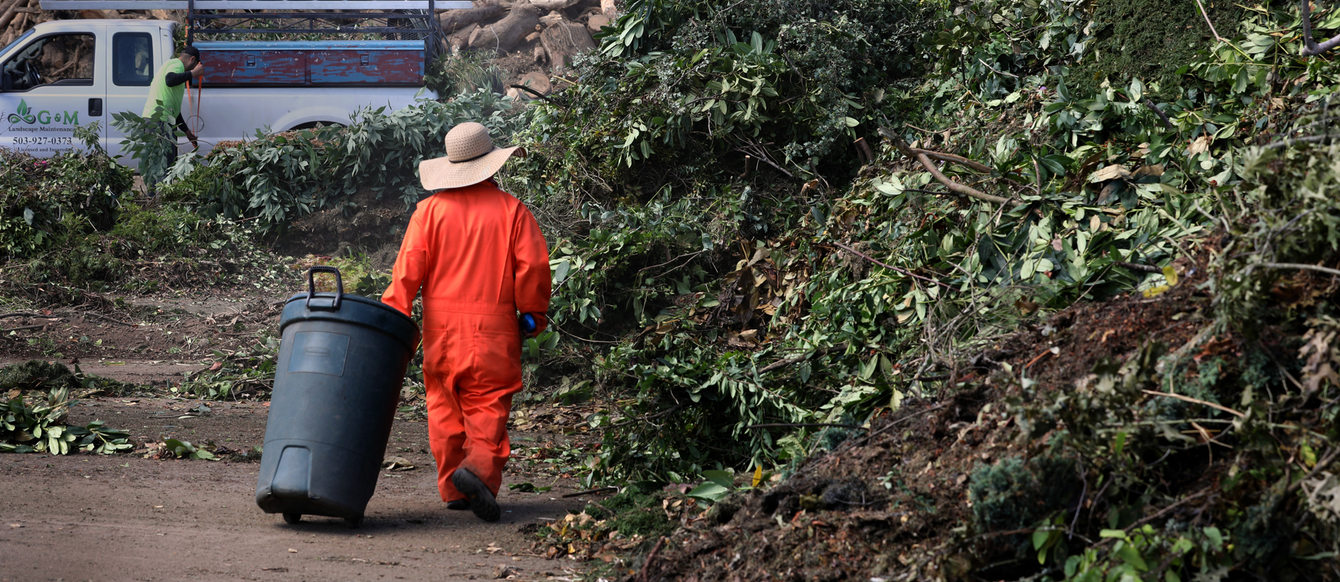 Workers tend to compost piles at Grimm's Fuel
