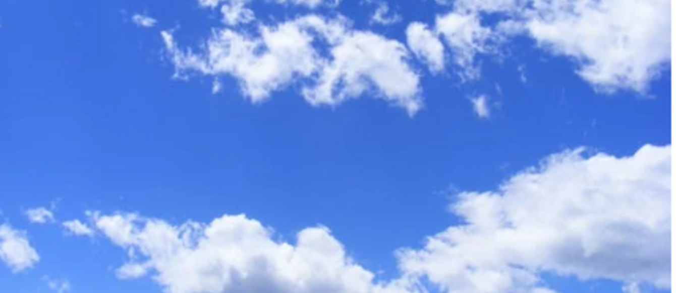 Fluffy white clouds against a blue sky.