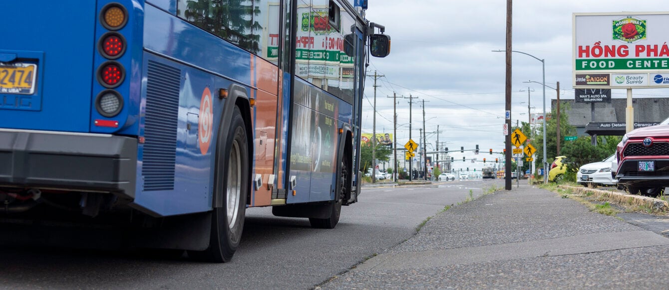 Image of a bus pulling up to a bus stop on 82nd Ave