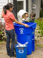 photo of mom and son emptying the recycling bin