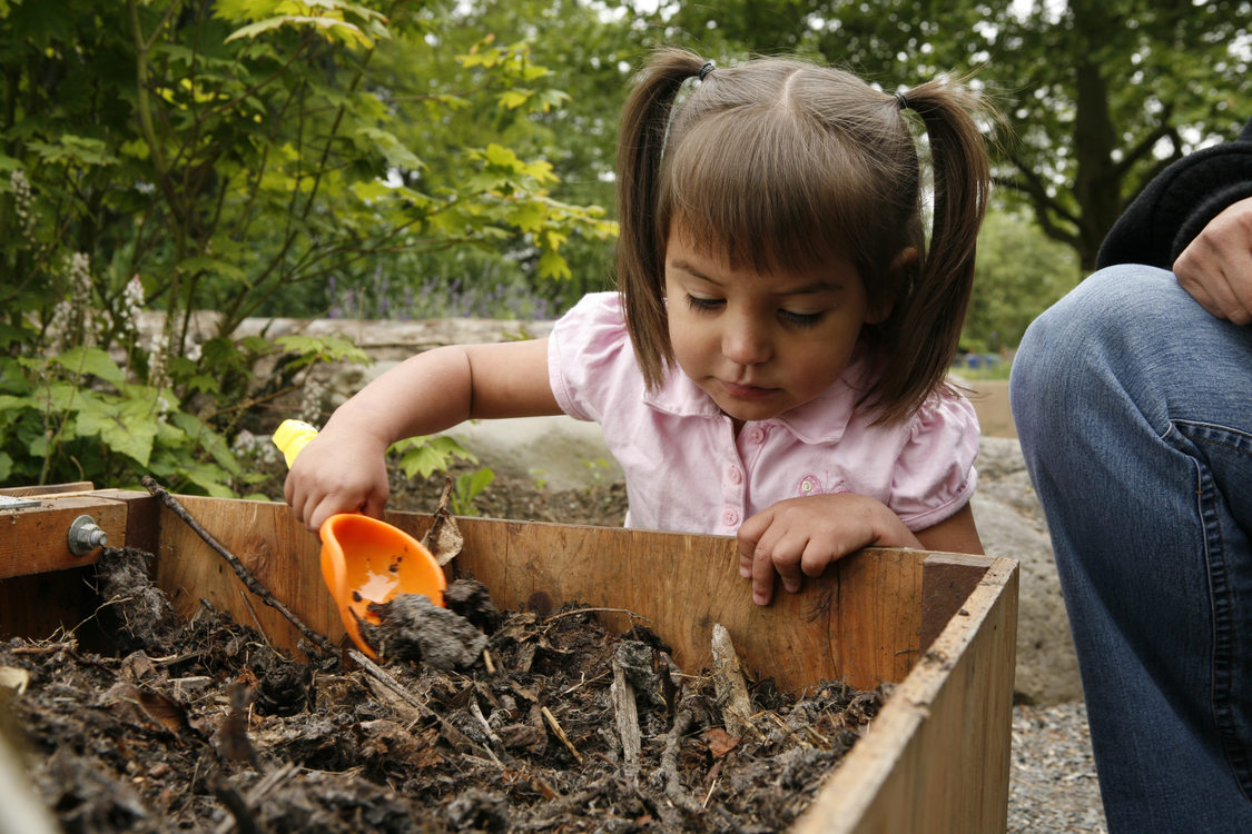 photo of a girl playing in the Blue Lake Natural Discovery Garden