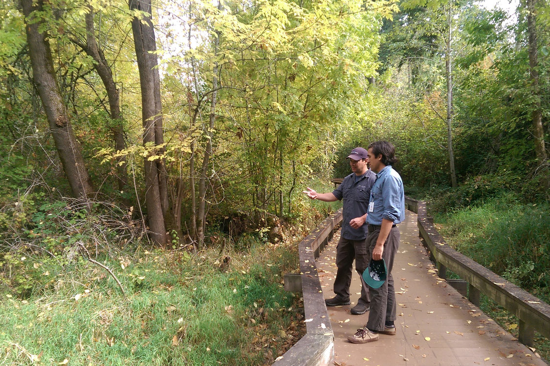 photo of two men on wooden bridge path at Willow Creek