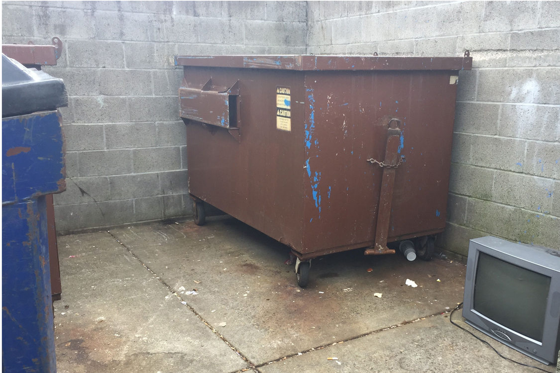 television next to dumpster