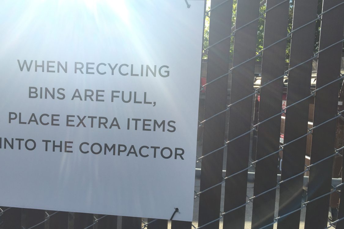 signs next to recycling bins with directions