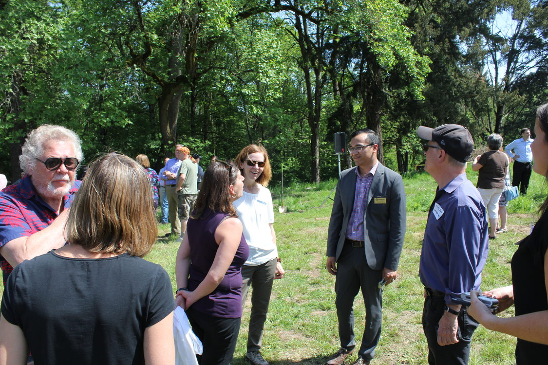 Community members and government officials chat at Orenco Woods' groundbreaking.