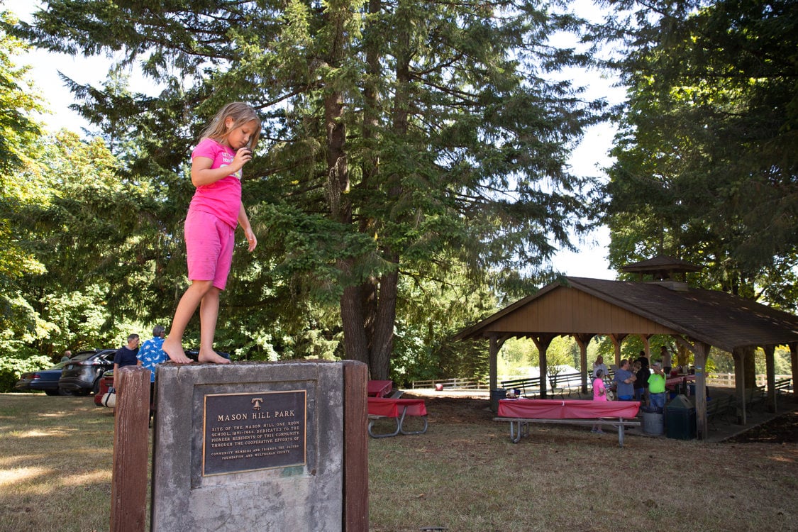 Girl standing on plaque at Mason Hill Regional Park