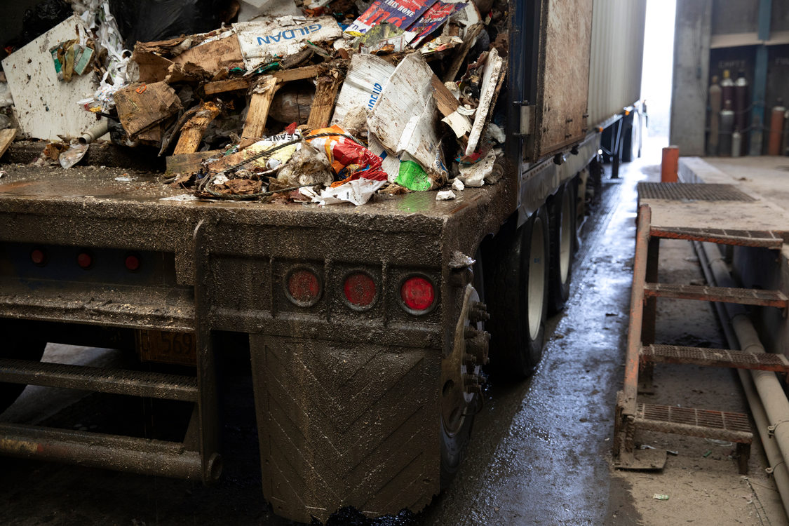 view of the inside of a truck trailer full of garbage