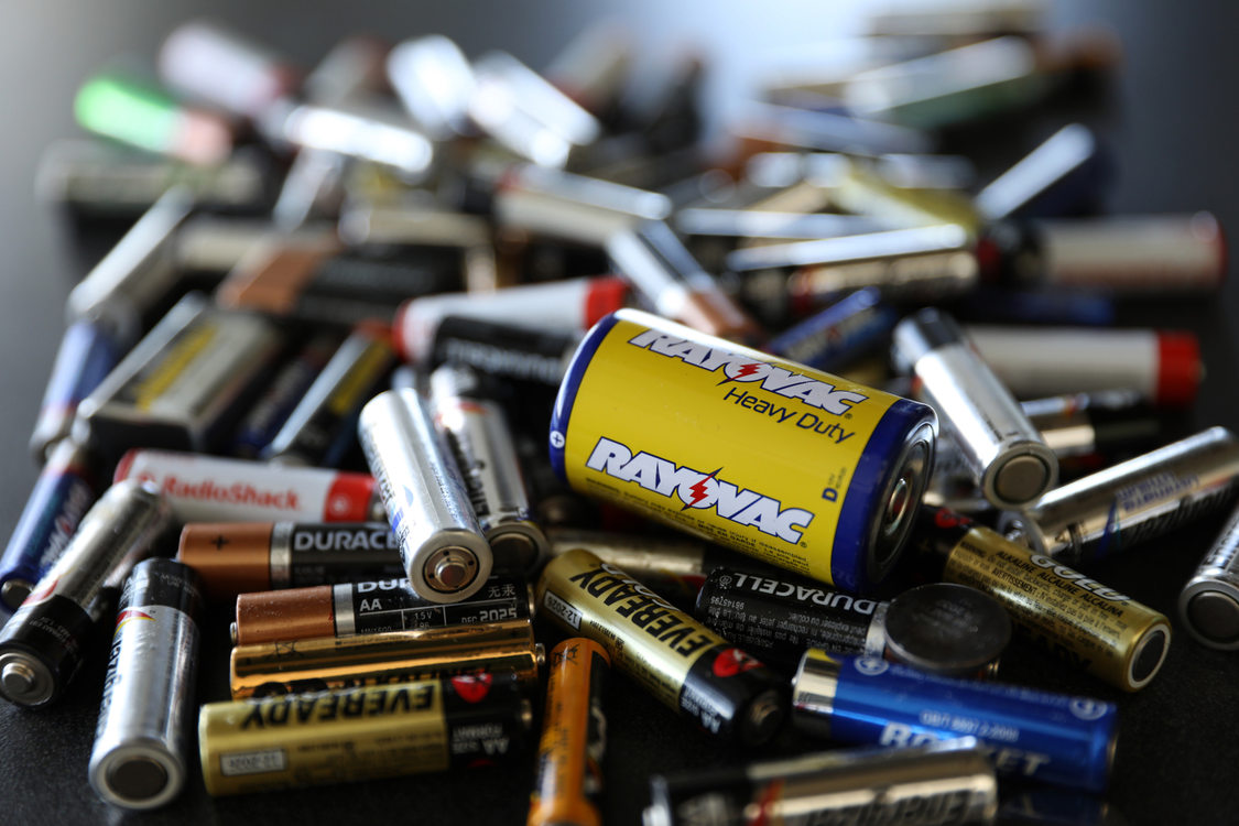 pile of batteries of varying sizes and types for disposal
