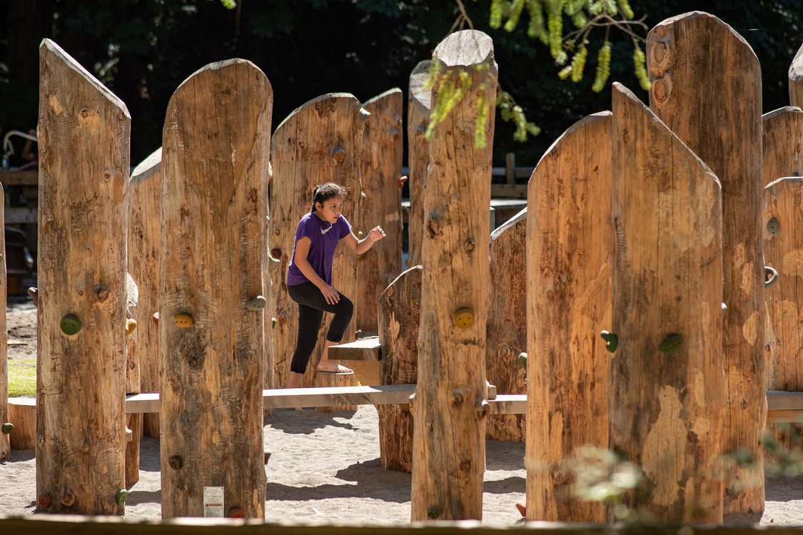 A child plays on the large wooden playground at Oxbow Regional Park. The playground was built to be accessible for children of a wide-range of abilities.