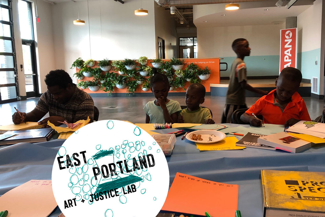 youth seated around a table at APANO working on the East Portland Art + Justice Lab program