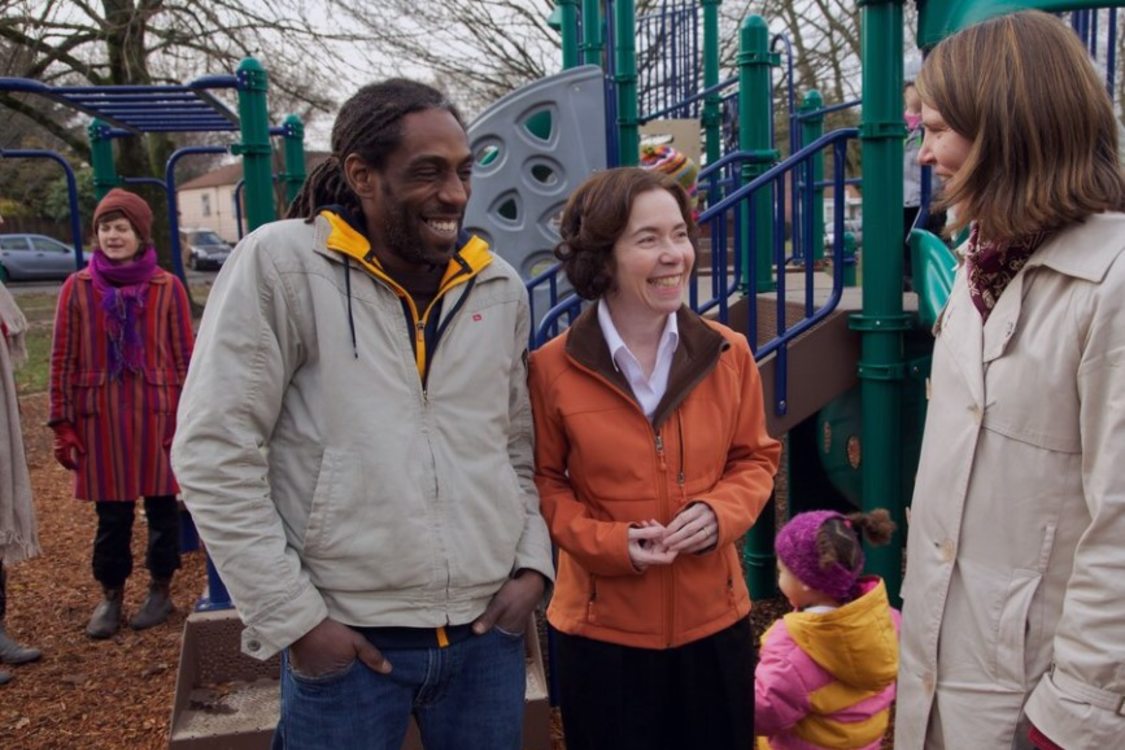 Metro Councilor for District 5, Mary Nolan speaks with community members in a park playground