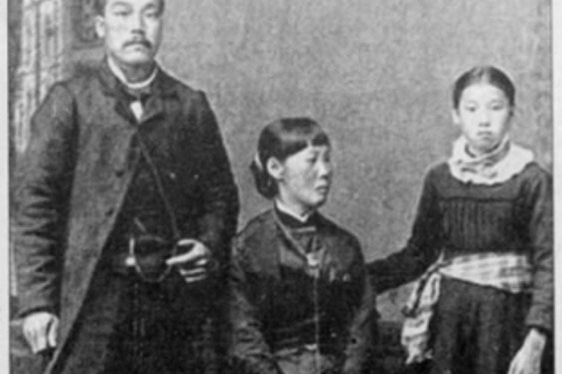 A photo from 1886 of three Japanese Americans wearing formal clothing.