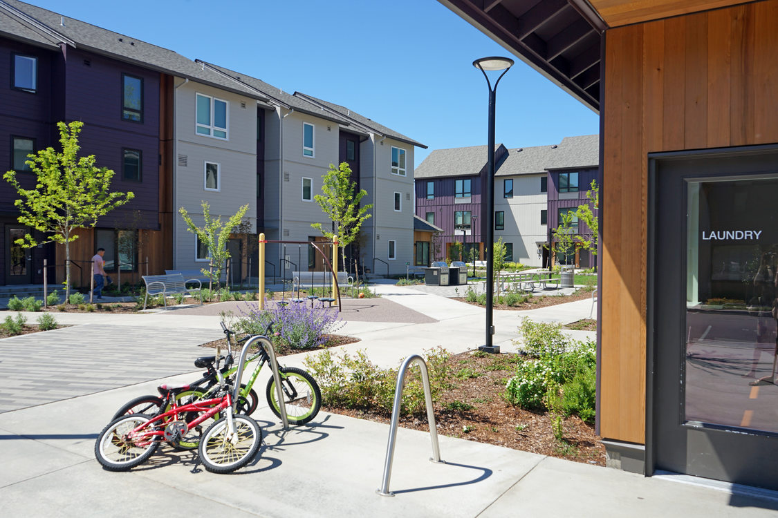 Multifamily apartment building courtyard with bikes locked to a rack.
