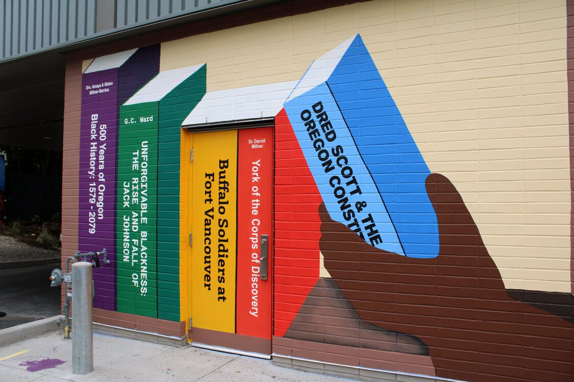 Mural with a series of books in rainbow colors. The books relate to Black history.