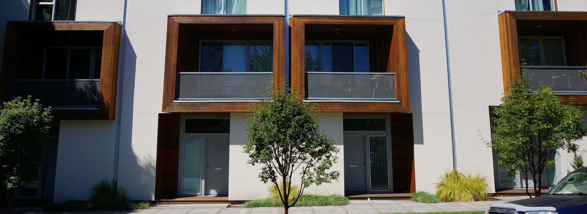 A street-side view of a row of modern-looking condos. 