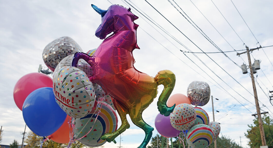 Bunch of mylar balloons including a rainbow unicorn