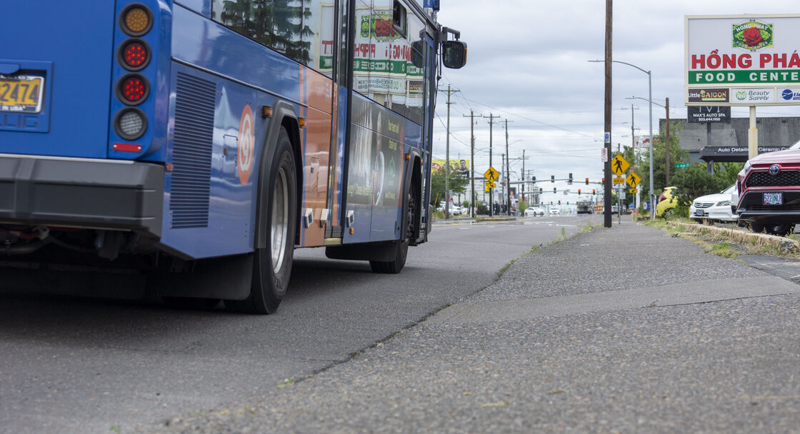 Image of a bus pulling up to a bus stop on 82nd Ave